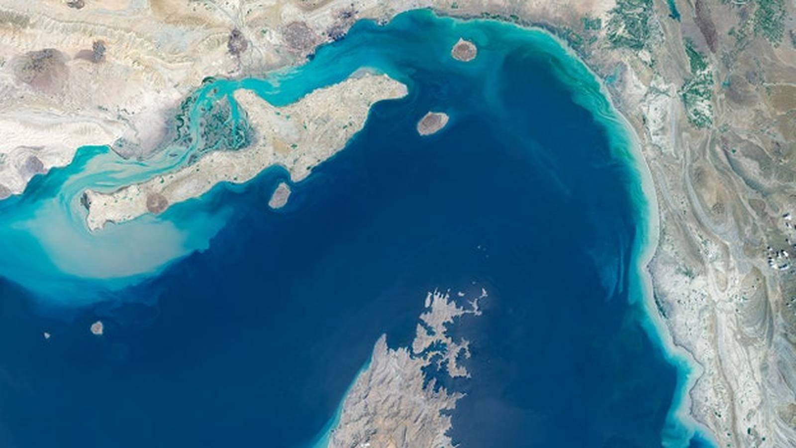 Satellite view showing the narrow Strait of Hormuz connecting the Persian Gulf and sea