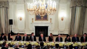 US President Donald Trump and major tech executives seated together at a White House meeting table