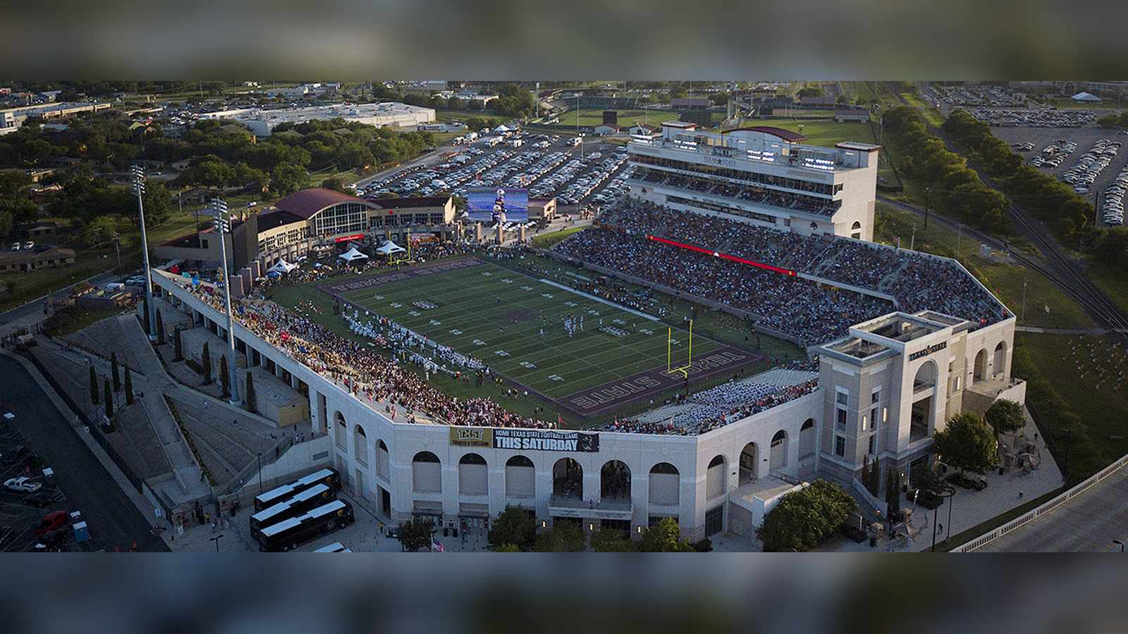 Aerial view of the Texas State University football stadium filled with spectators during a game