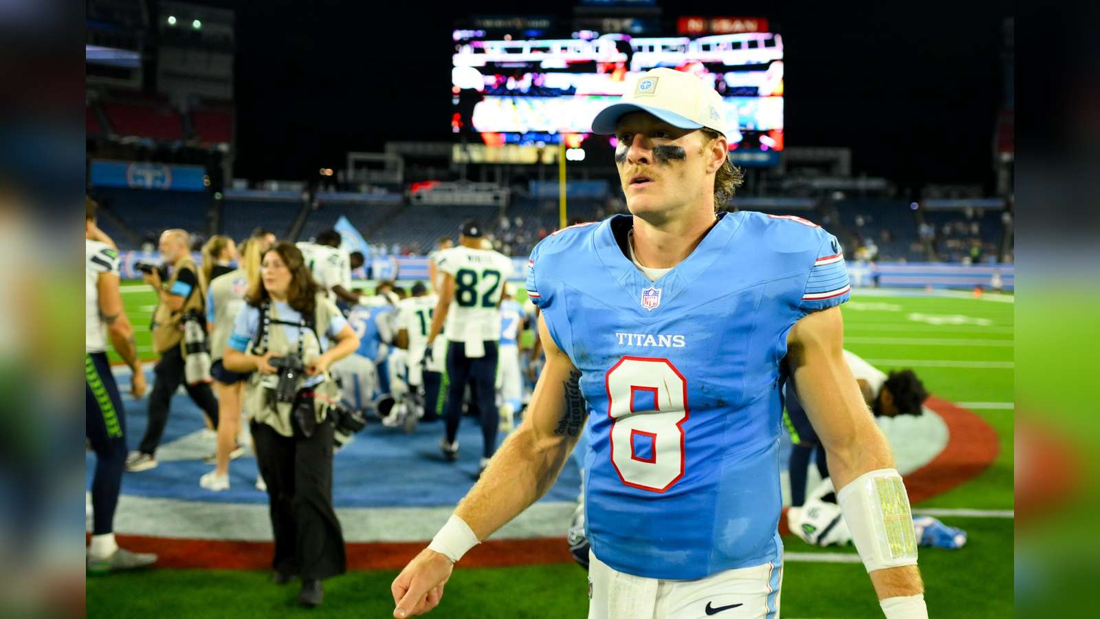 Quarterback Will Levis wearing a light blue Tennessee Titans jersey on the football field