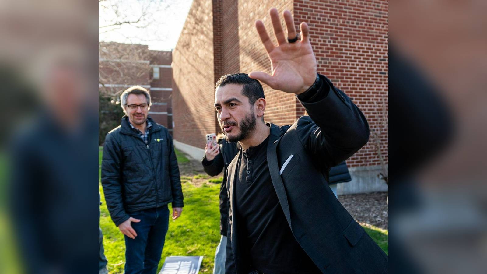 Abdul El-Sayed waving to supporters during a campaign rally in Michigan outdoors