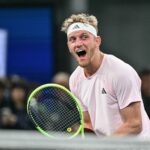 Alejandro Davidovich Fokina reacts with excitement on the court holding a tennis racket during the S