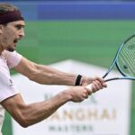 Alexander Zverev playing a tennis shot with his racket hitting a ball in Shanghai