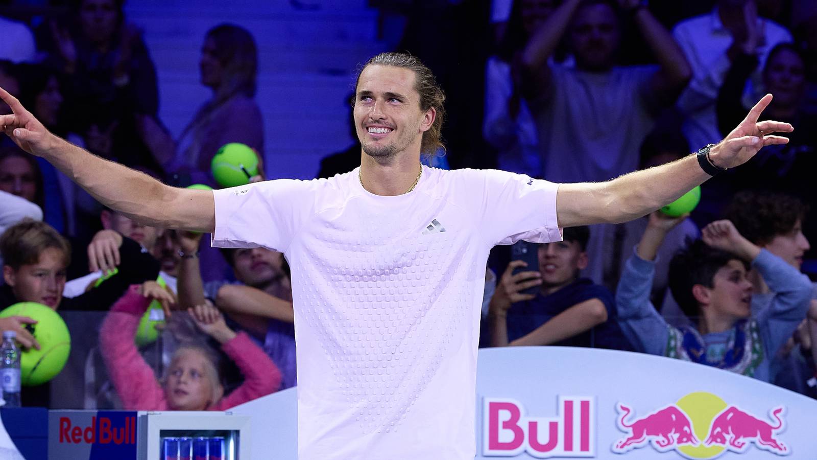 Alexander Zverev celebrating on the court with arms outstretched in front of spectators