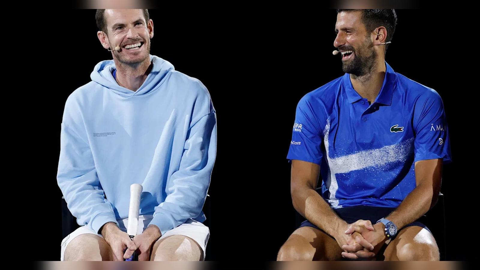 Andy Murray in a blue hoodie and Novak Djokovic laughing together on stage