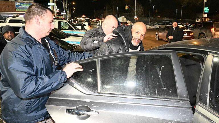 Law enforcement officials escorting suspect Angel Carrasco into a vehicle during the Bronx arrest