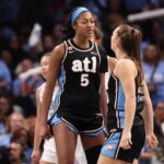 Angel Reese wearing an Atlanta Dream jersey on the basketball court during a game