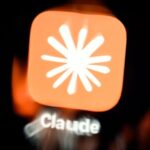 Close-up of the Claude AI app icon featuring a white starburst on an orange background