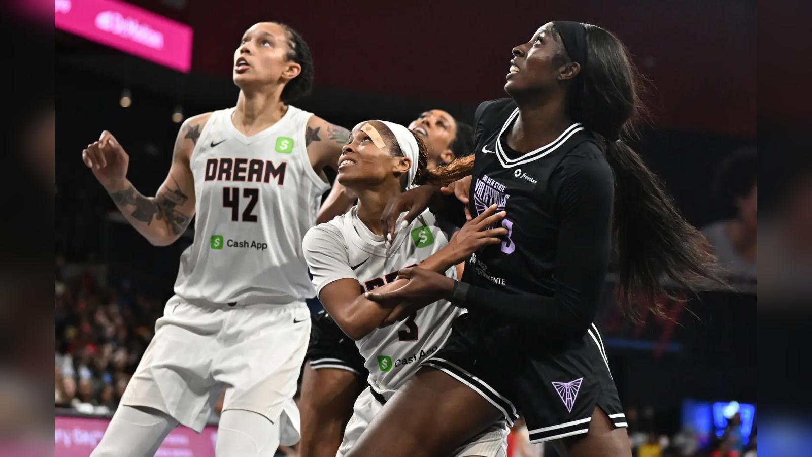 Basketball players from Atlanta Dream and Golden State Valkyries battling for position during a game