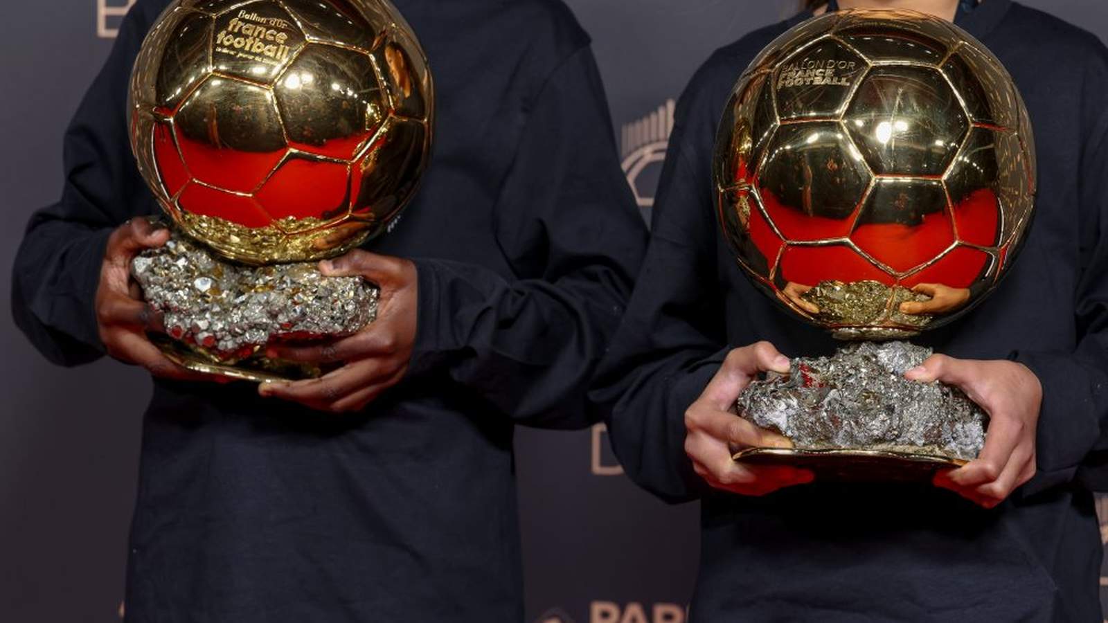 Ballon dOr trophies held at an awards ceremony archive photograph.