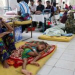 Patients and family members filling a crowded hospital ward in Bangladesh during a measles outbreak