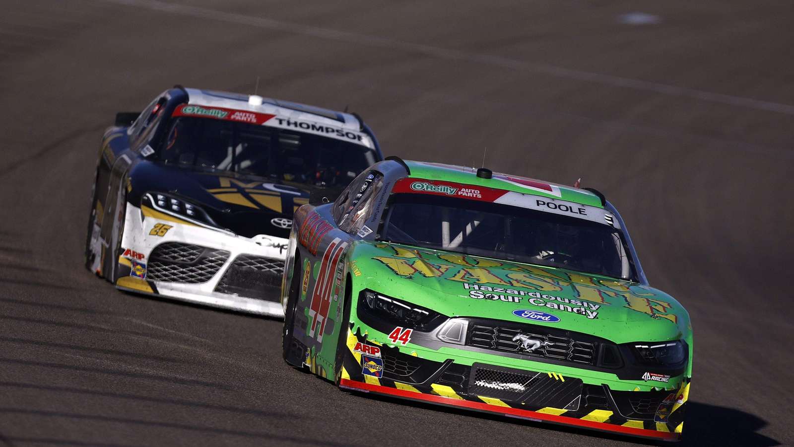 Brennan Poole driving the green number 44 race car on asphalt track