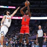 Chicago Bulls player Caleb Wilson shoots the ball against a Denver Nuggets defender during a preseas