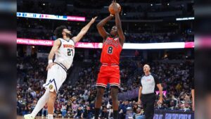 Chicago Bulls player Caleb Wilson shoots the ball against a Denver Nuggets defender during a preseas