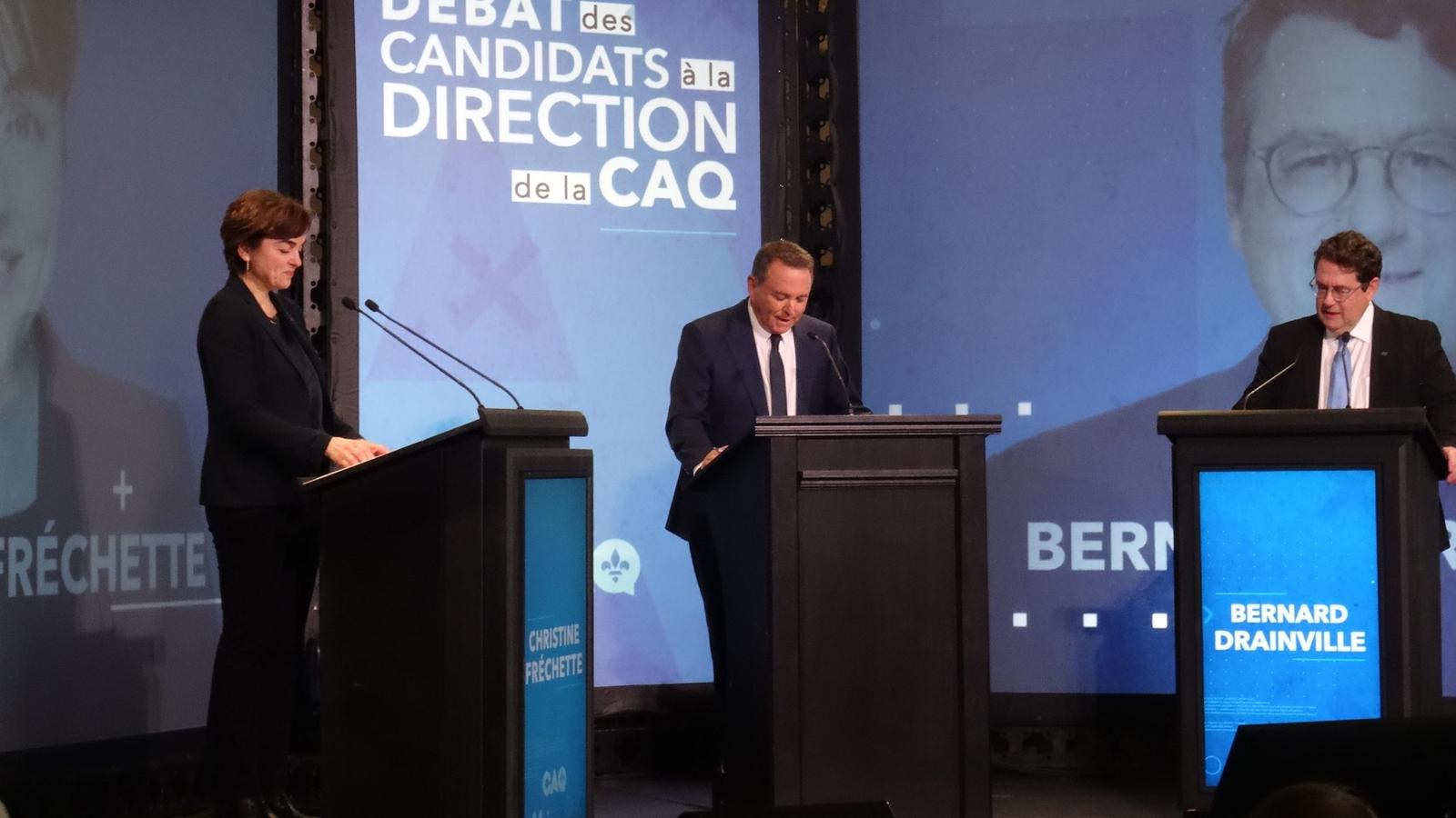 Christine Fréchette and Bernard Drainville standing at podiums during a CAQ leadership debate