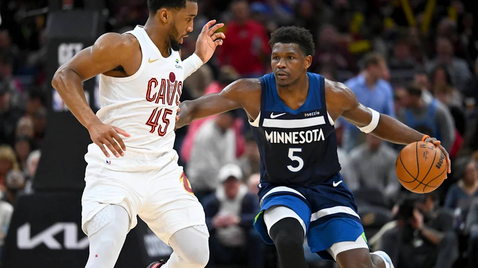 Basketball players from Cleveland Cavaliers and Minnesota Timberwolves competing during a game