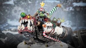 Detailed festive Da Red Gobbo miniature riding a red and white Squigmobile over snow
