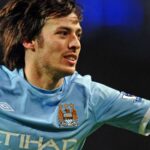 David Silva celebrating a goal wearing the light blue Manchester City jersey with Etihad sponsor