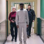 David Tennant and other actors walking down a prison corridor in the BBC drama Time