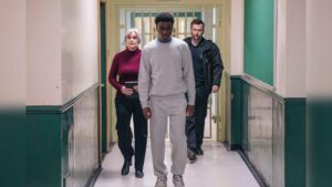 David Tennant and other actors walking down a prison corridor in the BBC drama Time