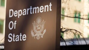Close up shot of the Department of State sign featuring the official seal