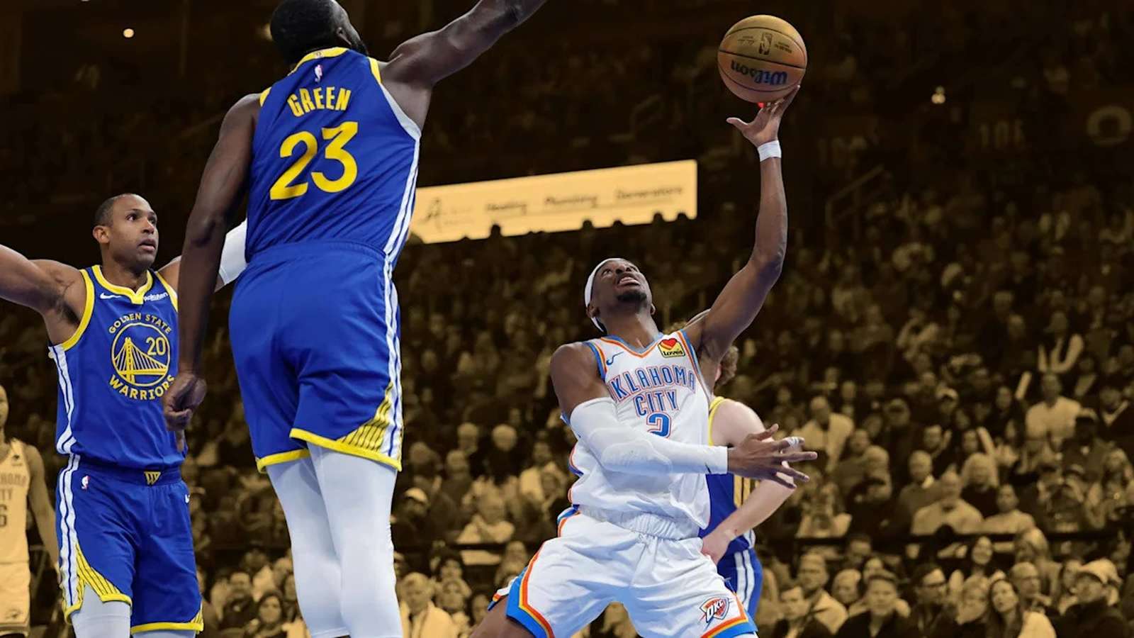 Draymond Green in Golden State Warriors uniform playing defense against Oklahoma City Thunder player