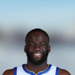 Portrait of Golden State Warriors forward Draymond Green smiling in his jersey
