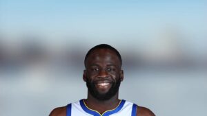 Portrait of Golden State Warriors forward Draymond Green smiling in his jersey