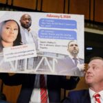 Senator Eric Schmitt and other individuals in a congressional hearing room holding a display with te