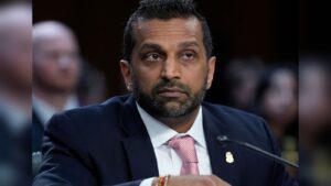 A man in a suit and tie testifying at a formal hearing