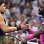 Frances Tiafoe shakes hands with Ben Shelton at the net following a match