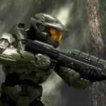 Master Chief in green armor holding an assault rifle in a jungle environment