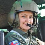 Navy 1st Lt. Hilal Aydın smiling inside an aircraft cockpit wearing a flight helmet