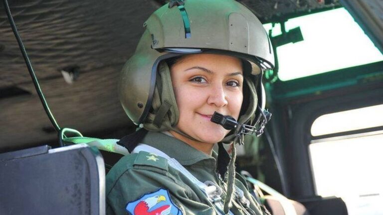 Navy 1st Lt. Hilal Aydın smiling inside an aircraft cockpit wearing a flight helmet