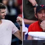 Hubert Hurkacz pumping his fist on court alongside coach Gilles Cervara watching