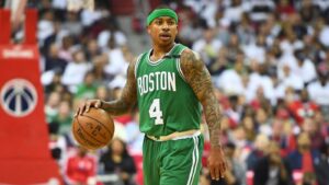 Isaiah Thomas dribbling basketball while wearing a green Boston Celtics jersey during a game