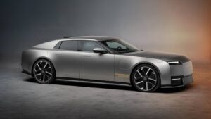 Sleek silver Jaguar Type 01 electric GT parked in a studio setting