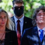 Argentine President Javier Milei standing with colleagues during a formal public appearance