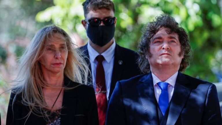 Argentine President Javier Milei standing with colleagues during a formal public appearance