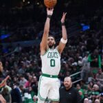 Boston Celtics player Jayson Tatum shoots a basketball during a game against the New York Knicks
