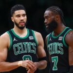 Boston Celtics players Jayson Tatum and Jaylen Brown talking on the court