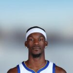 Portrait of basketball player Jimmy Butler wearing a white and blue Golden State Warriors jersey
