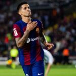 Joao Cancelo celebrating on the pitch wearing the FC Barcelona home kit during a match