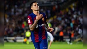 Joao Cancelo celebrating on the pitch wearing the FC Barcelona home kit during a match
