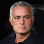 Manager Jose Mourinho with a focused expression looking ahead in a stadium seating area