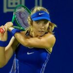 Katie Boulter playing tennis in a blue outfit holding a racket at the Japan Open