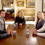 Cast members of the television series Line of Fire sitting around a wooden dining table