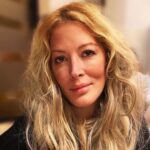 Close-up portrait of reality TV star Loana Petrucciani with long blonde hair looking at the camera