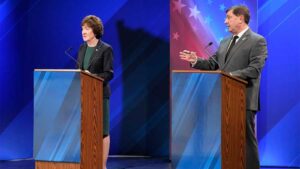 Susan Collins and Troy Jackson standing at podiums during a Maine Senate debate