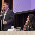 Nevada GOP House candidate Marty ODonnell speaking into a microphone at an event table